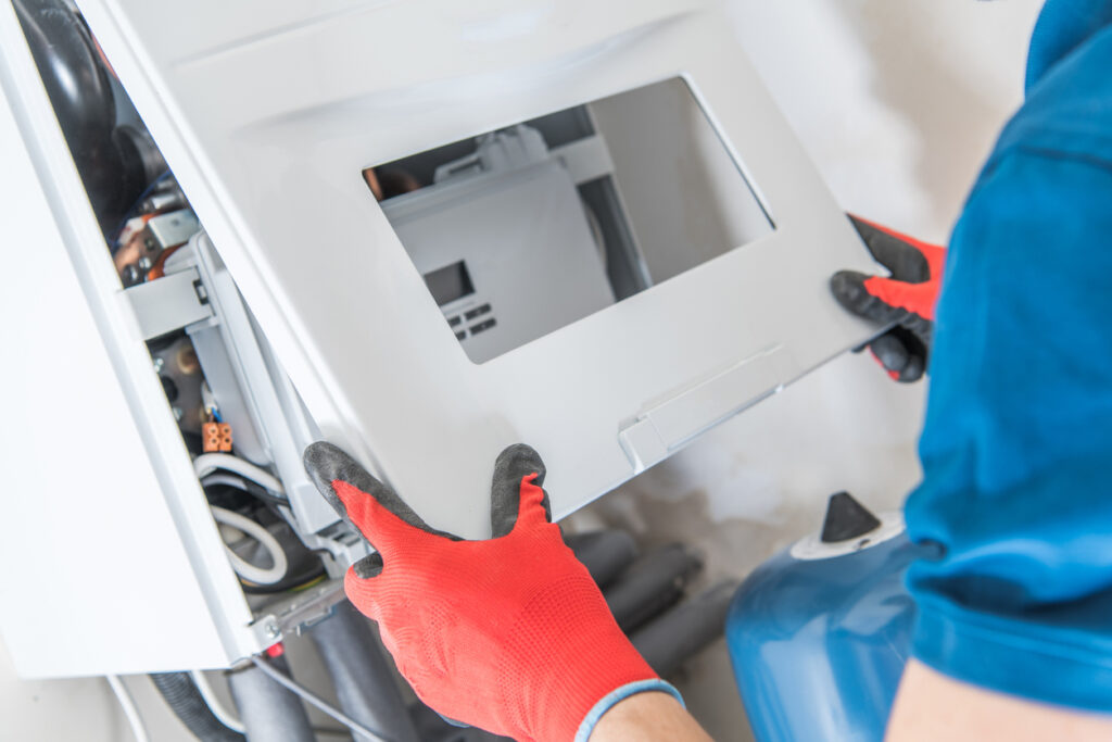 Technician installing a new heater in a Massachusetts home