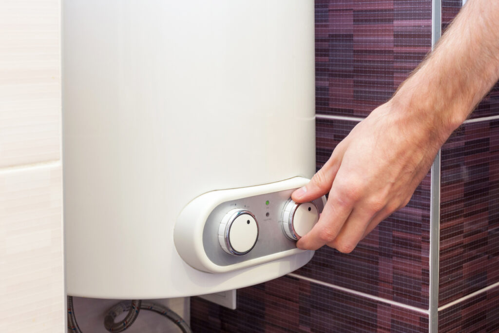 Close-up of man hands setting the temperature of water