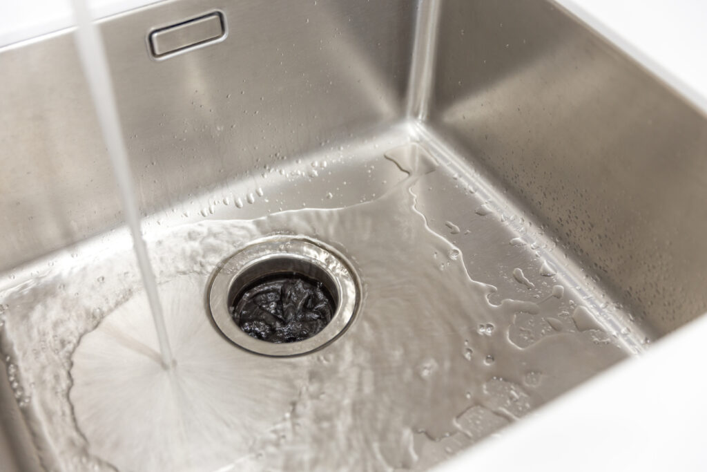 Stainless kitchen sink with food waste disposal